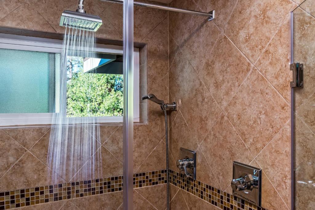 a bathroom with a shower with a window at Sheridan House Inn- Adult Only Accommodation in Williams