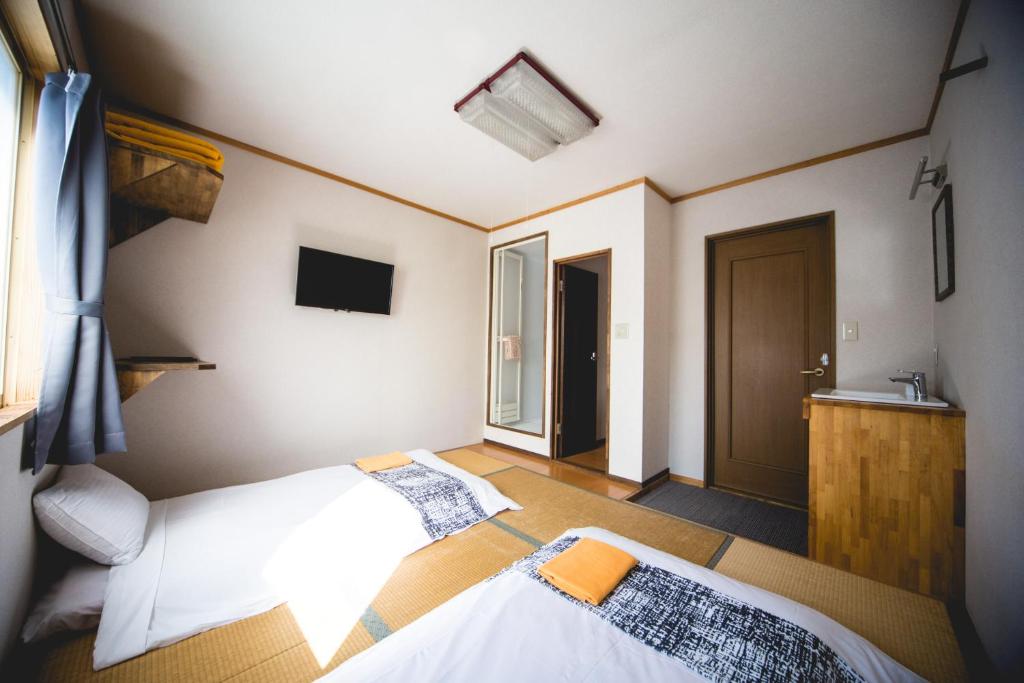 Postel nebo postele na pokoji v ubytování Hakuba Cortina Lodge