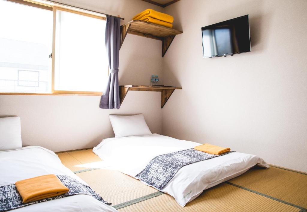 Postel nebo postele na pokoji v ubytování Hakuba Cortina Lodge