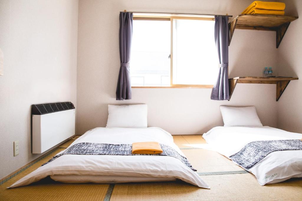 Postel nebo postele na pokoji v ubytování Hakuba Cortina Lodge