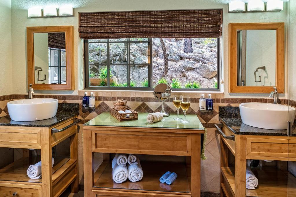 a bathroom with two sinks and two mirrors at Sheridan House Inn- Adult Only Accommodation in Williams