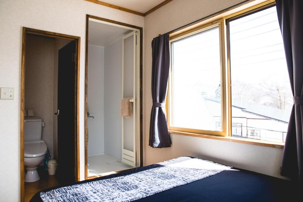 Postel nebo postele na pokoji v ubytování Hakuba Cortina Lodge