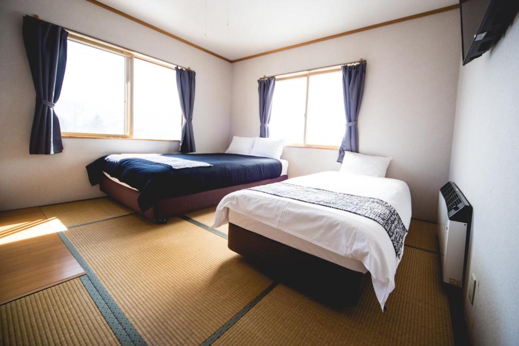 Postel nebo postele na pokoji v ubytování Hakuba Cortina Lodge