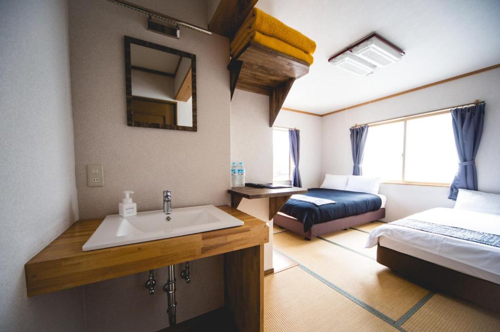 Postel nebo postele na pokoji v ubytování Hakuba Cortina Lodge