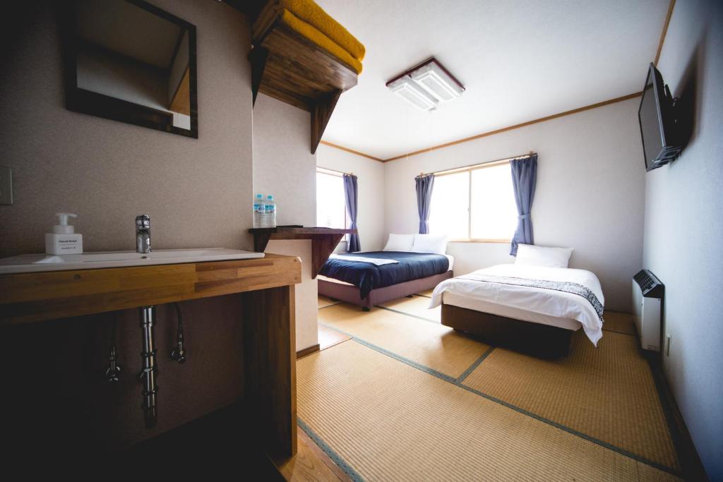 Postel nebo postele na pokoji v ubytování Hakuba Cortina Lodge