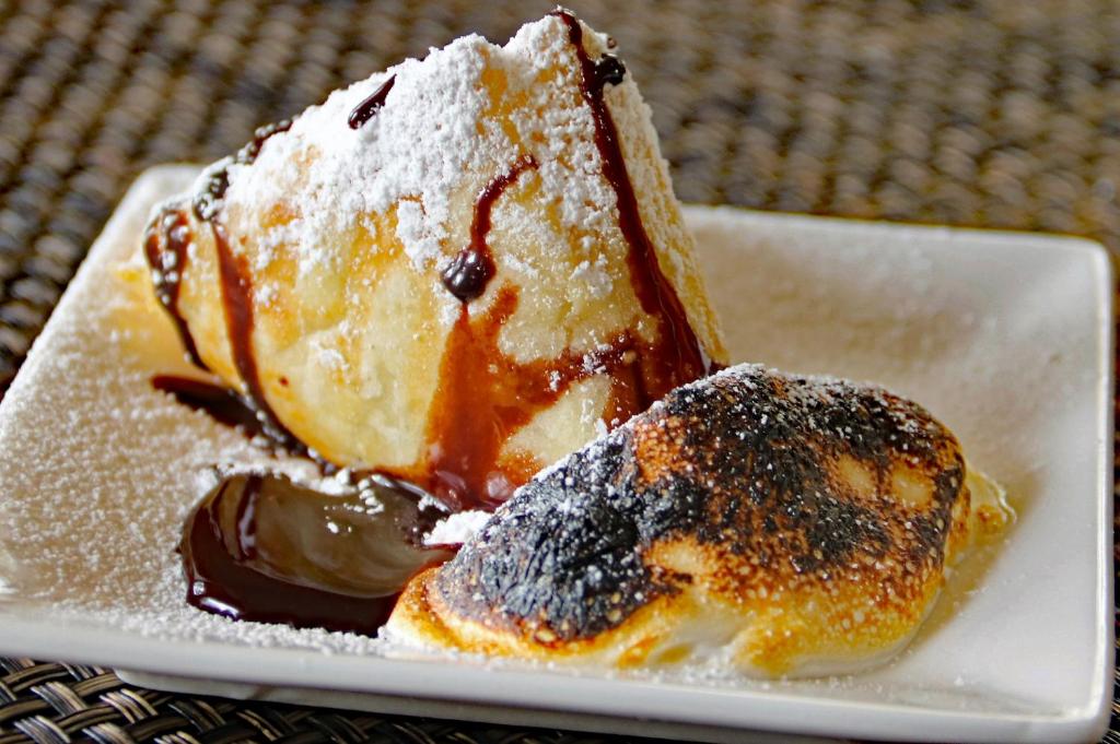 a piece of cake on a plate with chocolate at Sheridan House Inn- Adult Only Accommodation in Williams