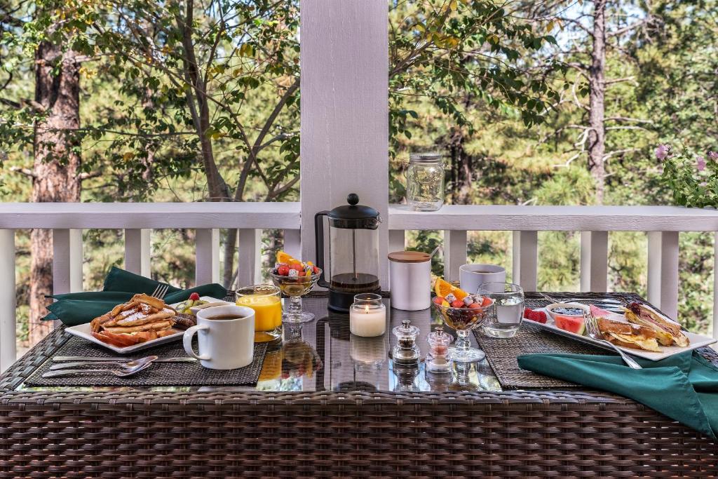 a table with food and drinks on a porch at Sheridan House Inn- Adult Only Accommodation in Williams