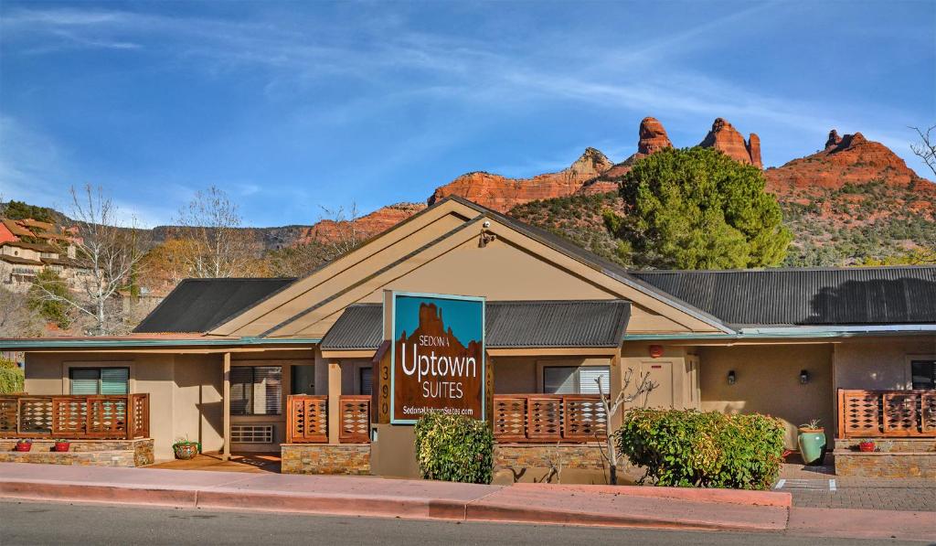 a building with a sign with a mountain in the background at Sedona Uptown Suites in Sedona