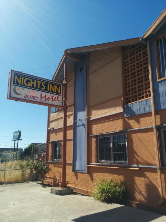 a building with a sign that reads nights inn motel at Nights Inn Motel in Oakland