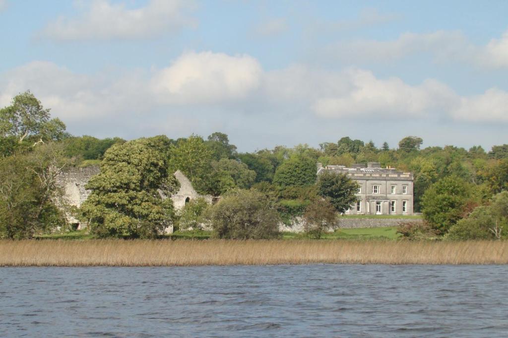 a large house on the shore of a body of water at Temple House in Ballymote