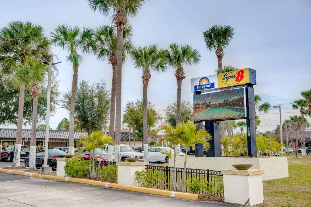 a gas station with palm trees in a parking lot at Super 8 by Wyndham St. Petersburg in St Petersburg