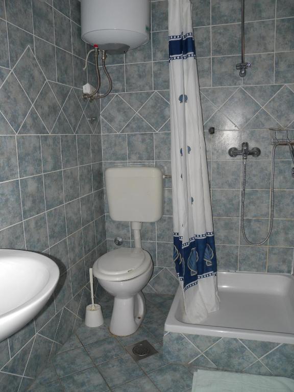 a bathroom with a toilet and a sink and a shower at Apartment Lopar 28 in Lopar