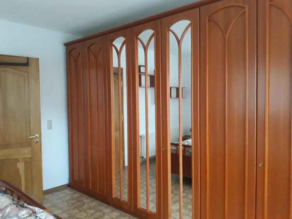 a room with wooden closet doors with a bedroom at 5 Gartenstraße in Angermünde