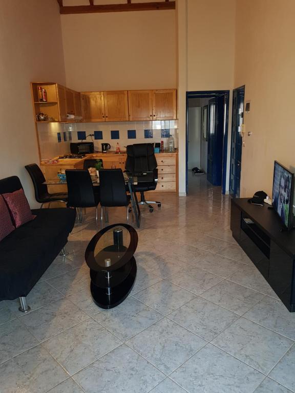 a living room with a couch and chairs and a table at SANTA MARIA Cape Verde in Santa Maria