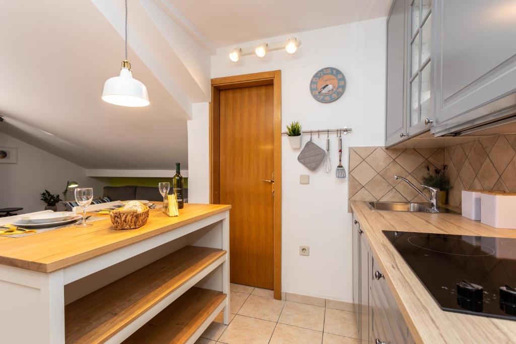 a kitchen with a wooden counter top and a sink at Pansion Tina in Šilo