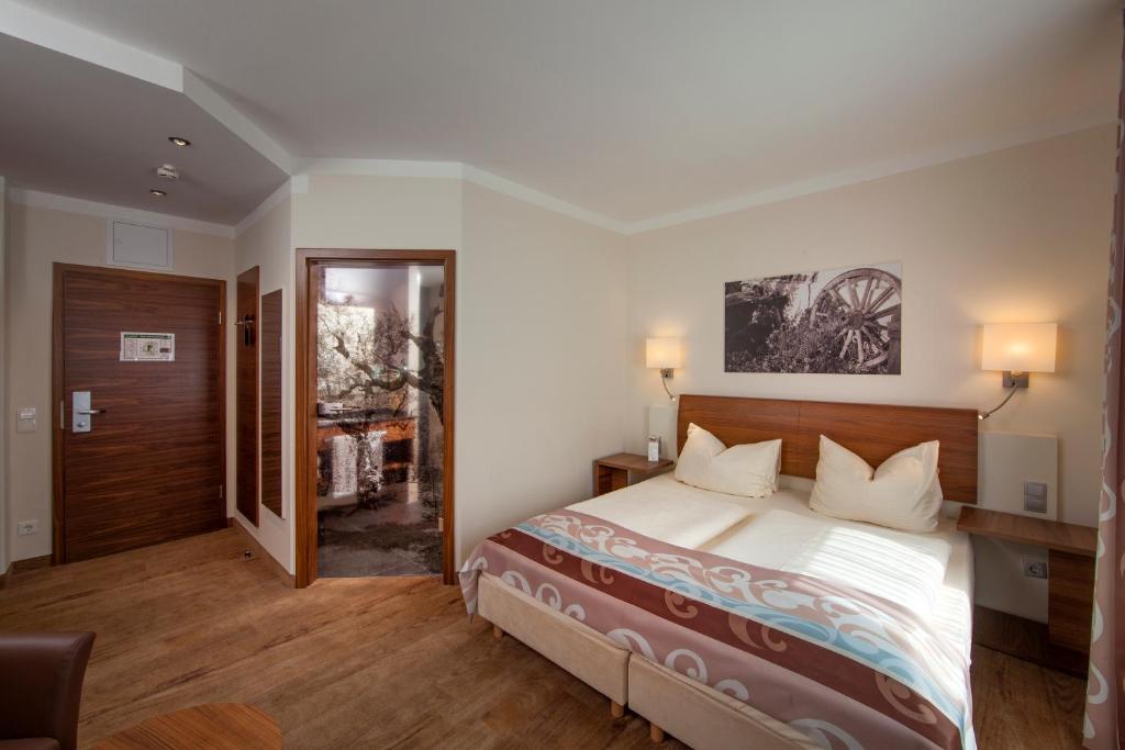 Postel nebo postele na pokoji v ubytování Hotel Greinwald