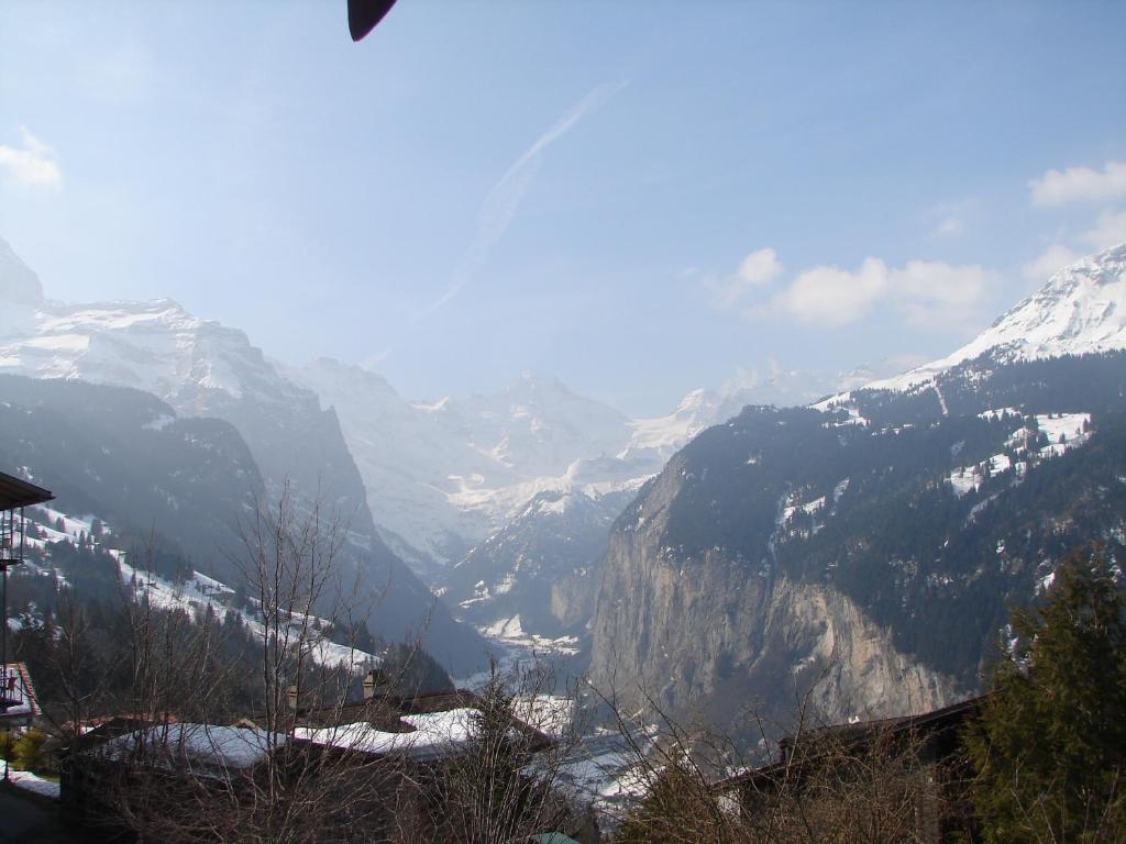 a view of a mountain valley with snow covered mountains at Chalet Gerbera in Wengen