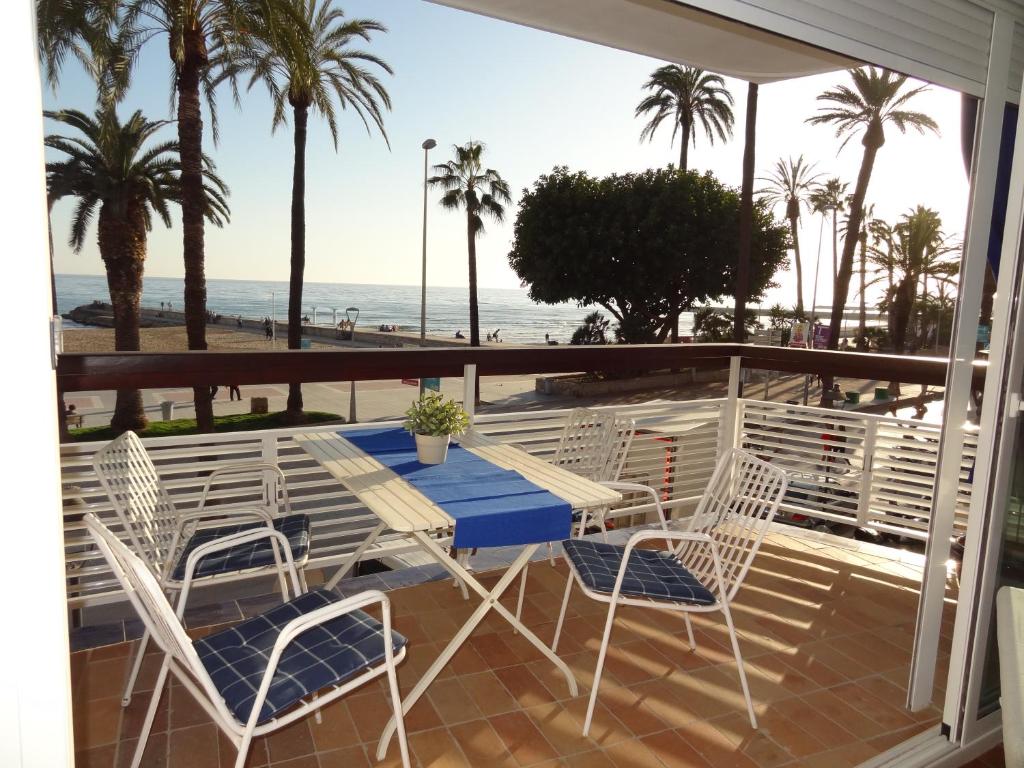 a patio with a table and chairs and the beach at Penelope Apart in Sitges