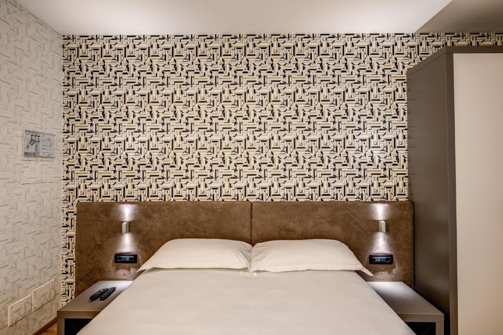 Un ou plusieurs lits dans un hébergement de l'établissement Colosseo Prestige Rooms