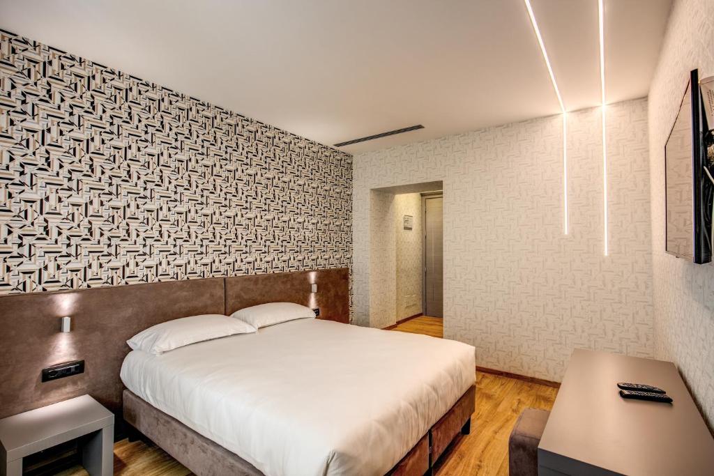 Un ou plusieurs lits dans un hébergement de l'établissement Colosseo Prestige Rooms