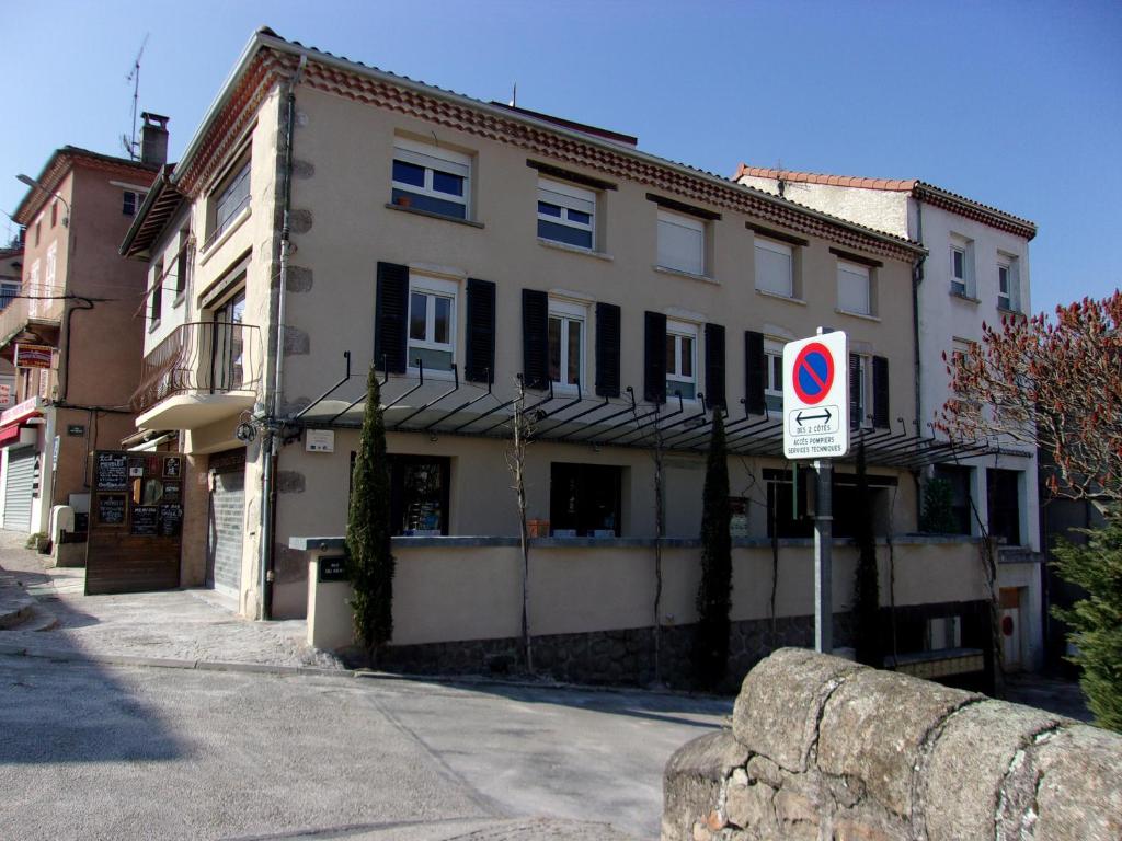 a building with a no parking sign in front of it at La Mezzanine in Satillieu