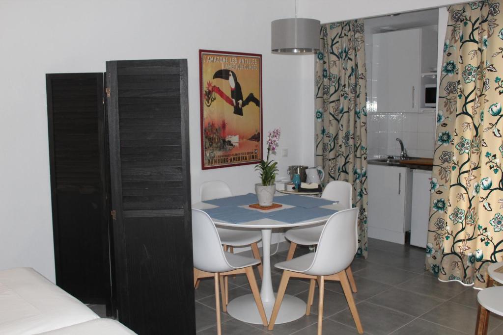 a dining room with a blue table and white chairs at Studio Occidental banus in Marbella