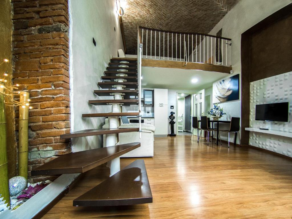 a staircase in a room with a brick wall at IDEAL LOFT IN CENTRO TORINO in Turin