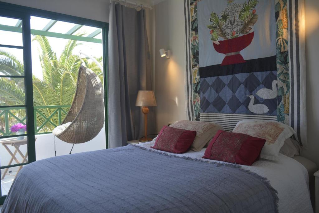 a bedroom with a bed and a large window at El Marinero in Puerto del Carmen