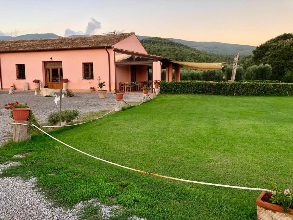 a house with a lawn in front of it at Agriturismo Ristorante Monte Argentario in Monte Argentario