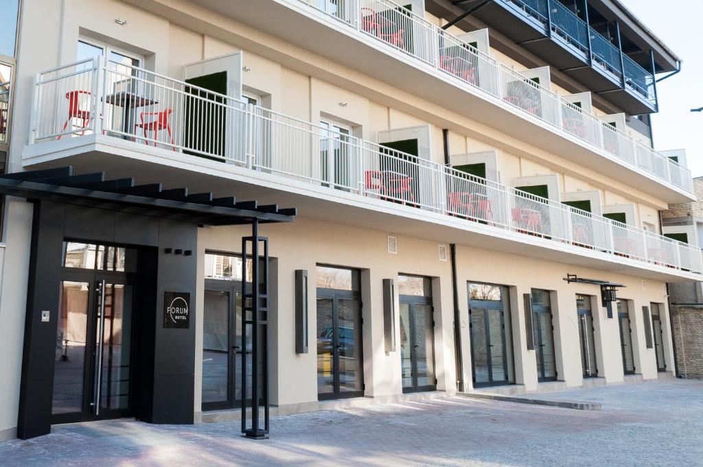 a building with a balcony on top of it at Hotel Forum Garni in Subotica