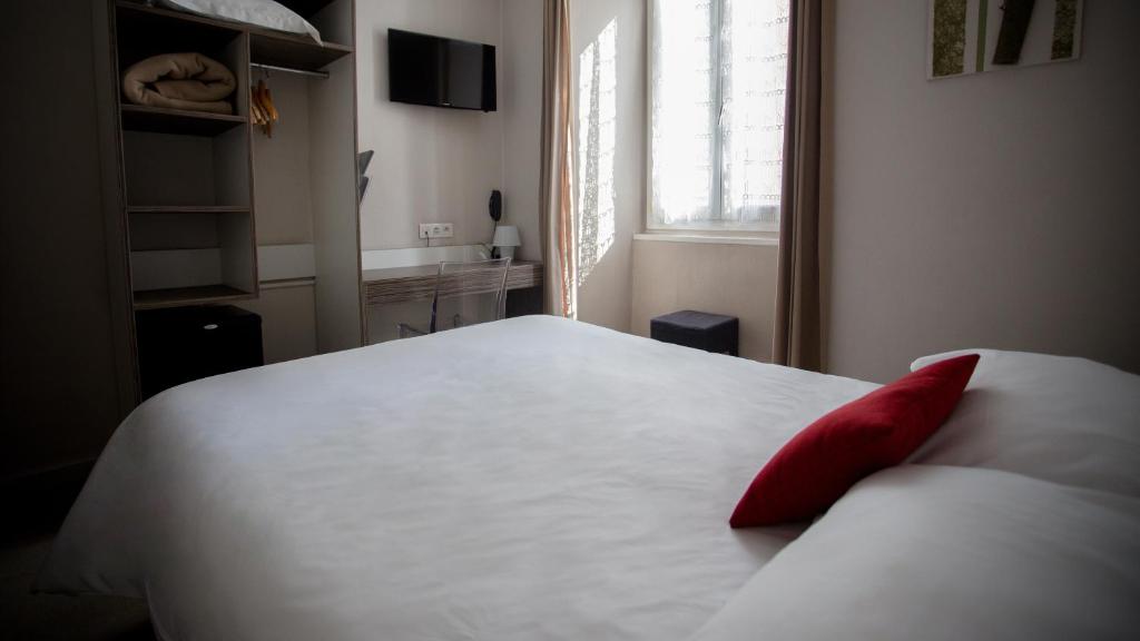Postel nebo postele na pokoji v ubytování Hôtel Napoléon