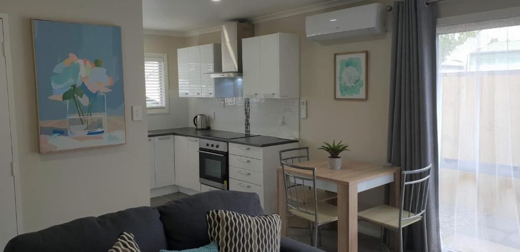 a kitchen with a couch and a table in a room at Rose Apartments Unit 6 Central Rotorua-Accommodation & Spa in Rotorua