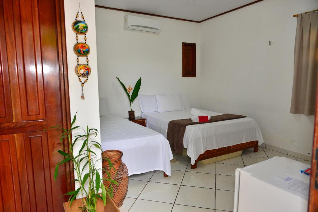 Postel nebo postele na pokoji v ubytování Pousada Sombra do Cajueiro