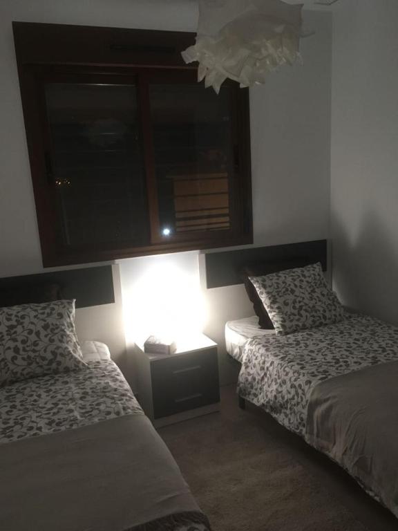 A bed or beds in a room at Oriuelha Costa Terrazas de Campoamor