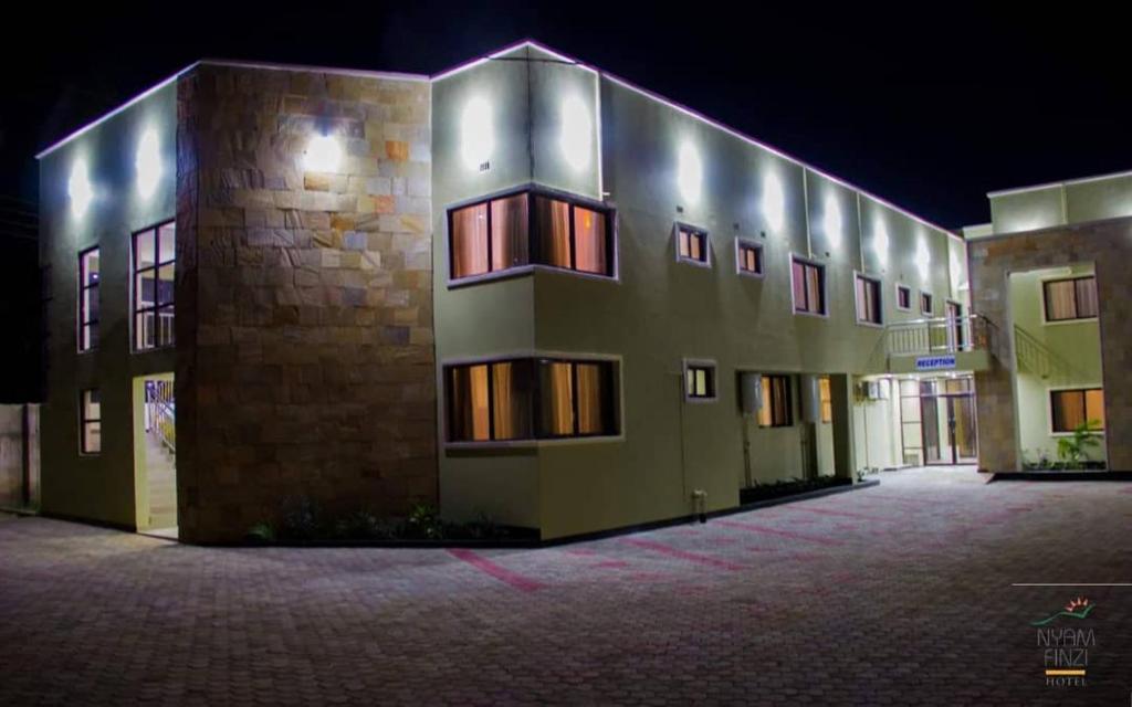 a building that is lit up at night at Nyamfinzi Hotel in Chipata