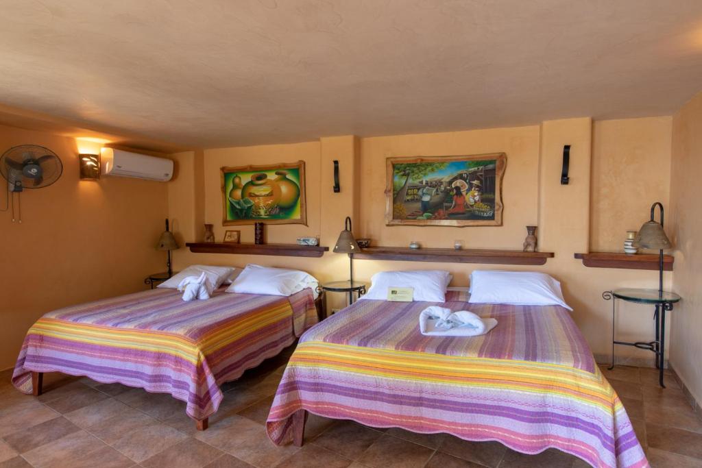 Postel nebo postele na pokoji v ubytování Villa Mango B&B