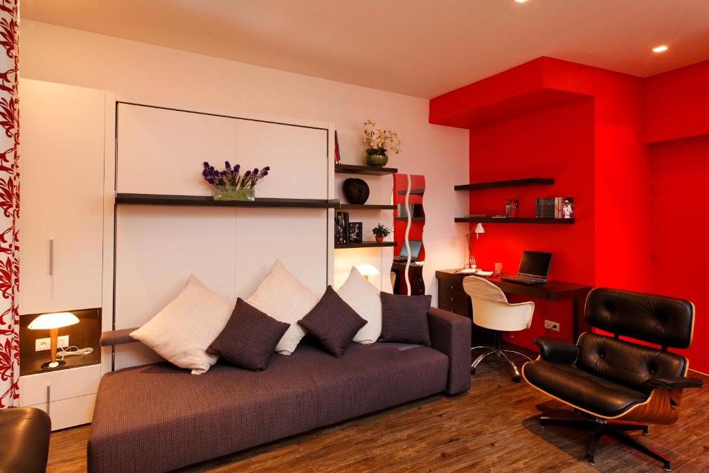 a living room with a couch and a desk at Studio La Savoyarde - Vision Luxe in Menthon-Saint-Bernard