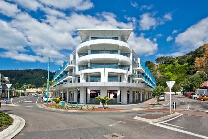 a large white building on the side of a street at Quayside Luxury Apartments in Whakatane