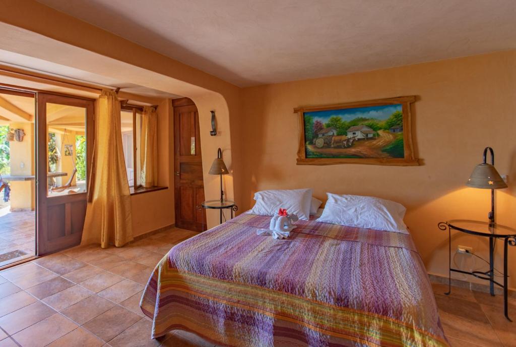 Postel nebo postele na pokoji v ubytování Villa Mango B&B