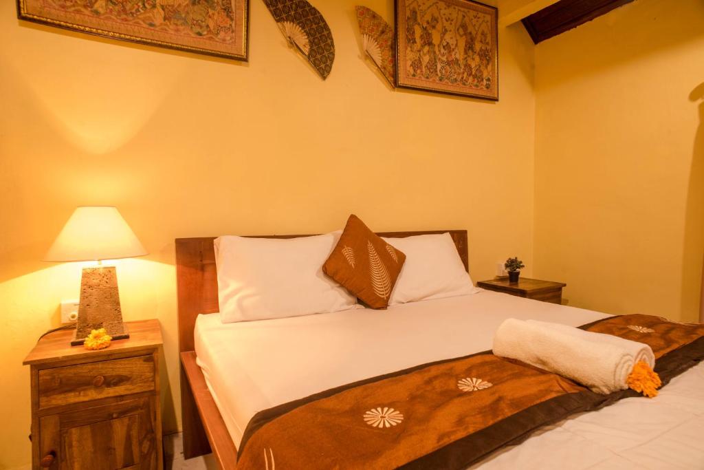 Postel nebo postele na pokoji v ubytování Kamar Suci House