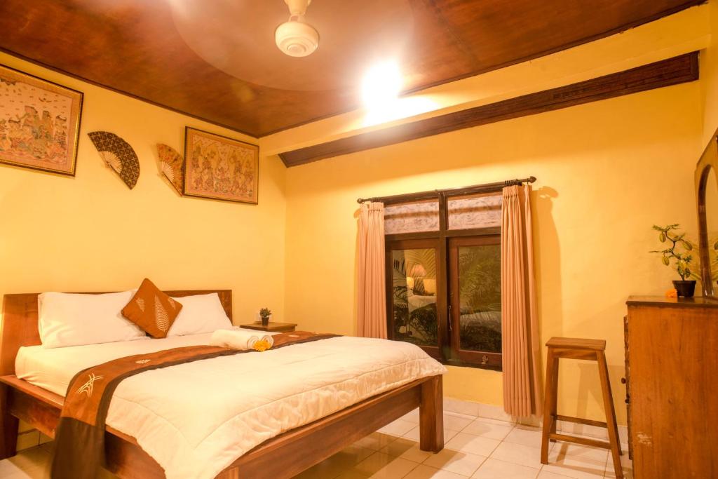 Postel nebo postele na pokoji v ubytování Kamar Suci House