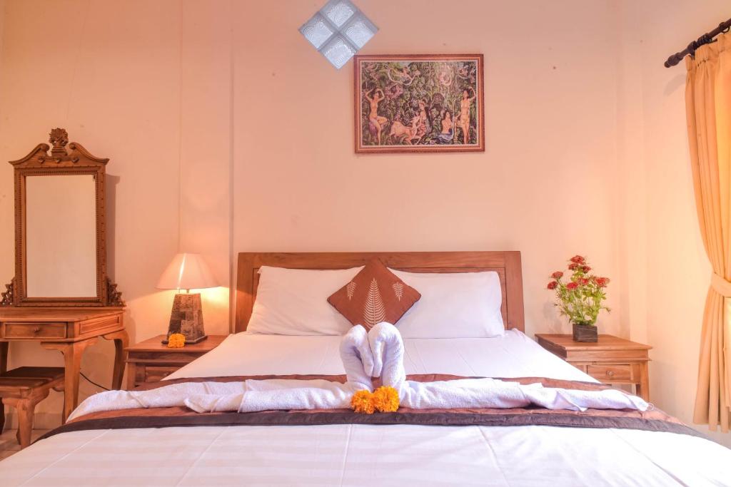 Postel nebo postele na pokoji v ubytování Kamar Suci House