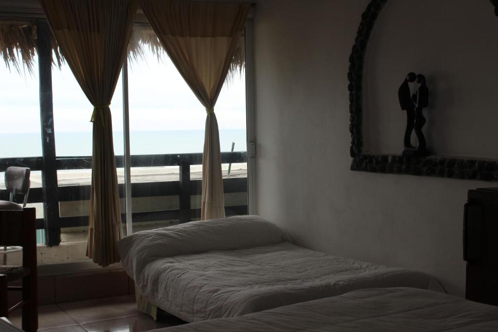 Postel nebo postele na pokoji v ubytování Hotel Villas del Rey