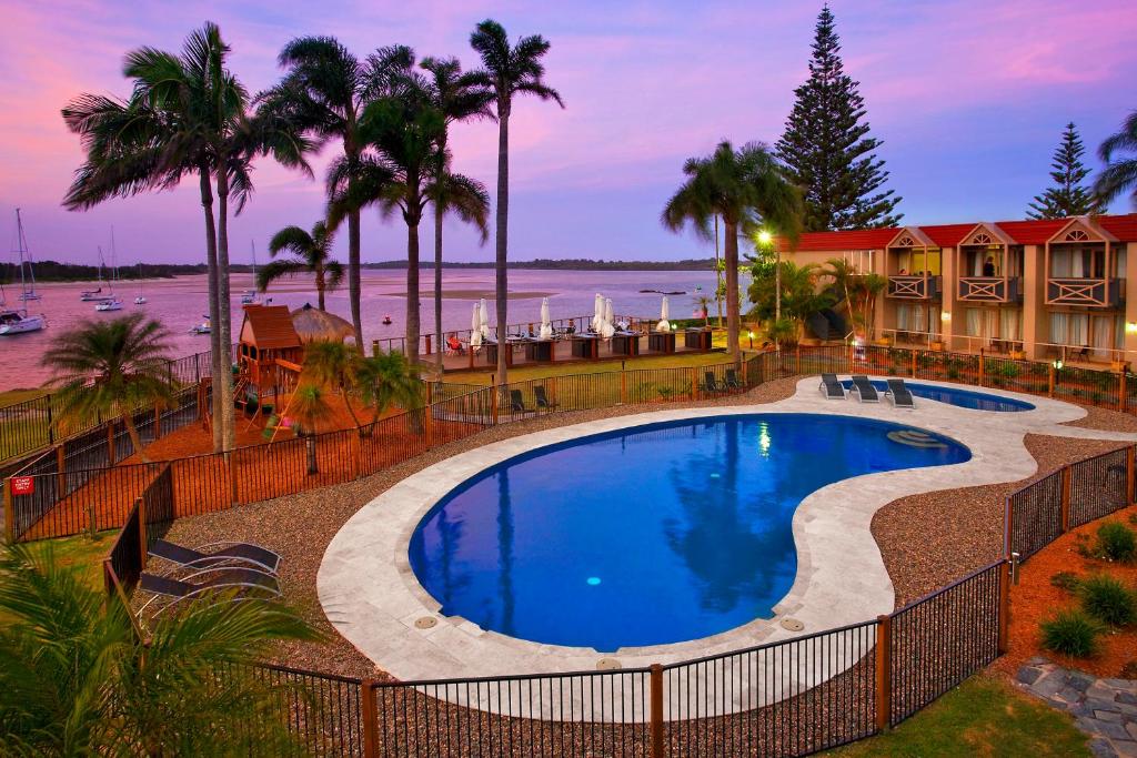 a beach with a pool and a swimming pool at Waters Edge Port Macquarie in Port Macquarie