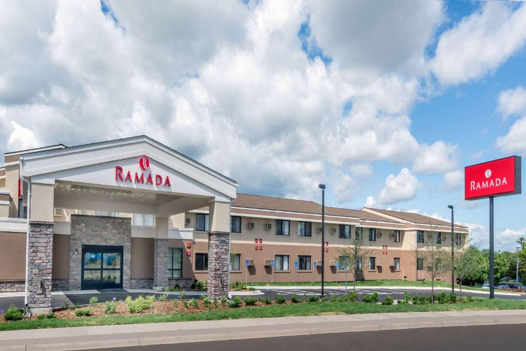 a large building with a sign on the side of it at Ramada by Wyndham Minneapolis Golden Valley in Minneapolis