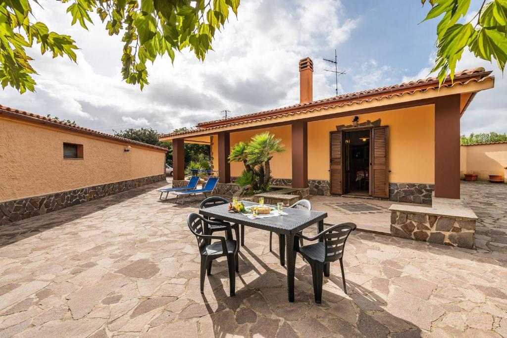 a patio with a table and chairs in front of a house at Holiday home in Santa Maria La Palma 31431 in Santa Maria la Palma