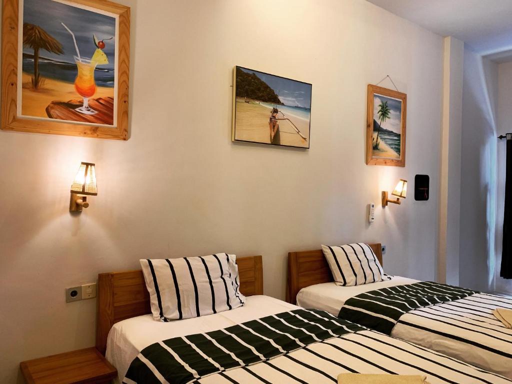 Postel nebo postele na pokoji v ubytování Lazy Inn Kuta Lombok