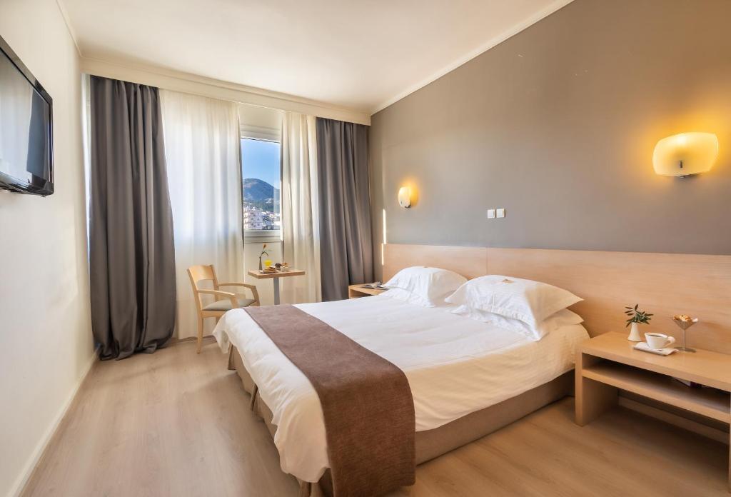 a hotel room with a large bed and a window at Nestos Hotel in Xanthi