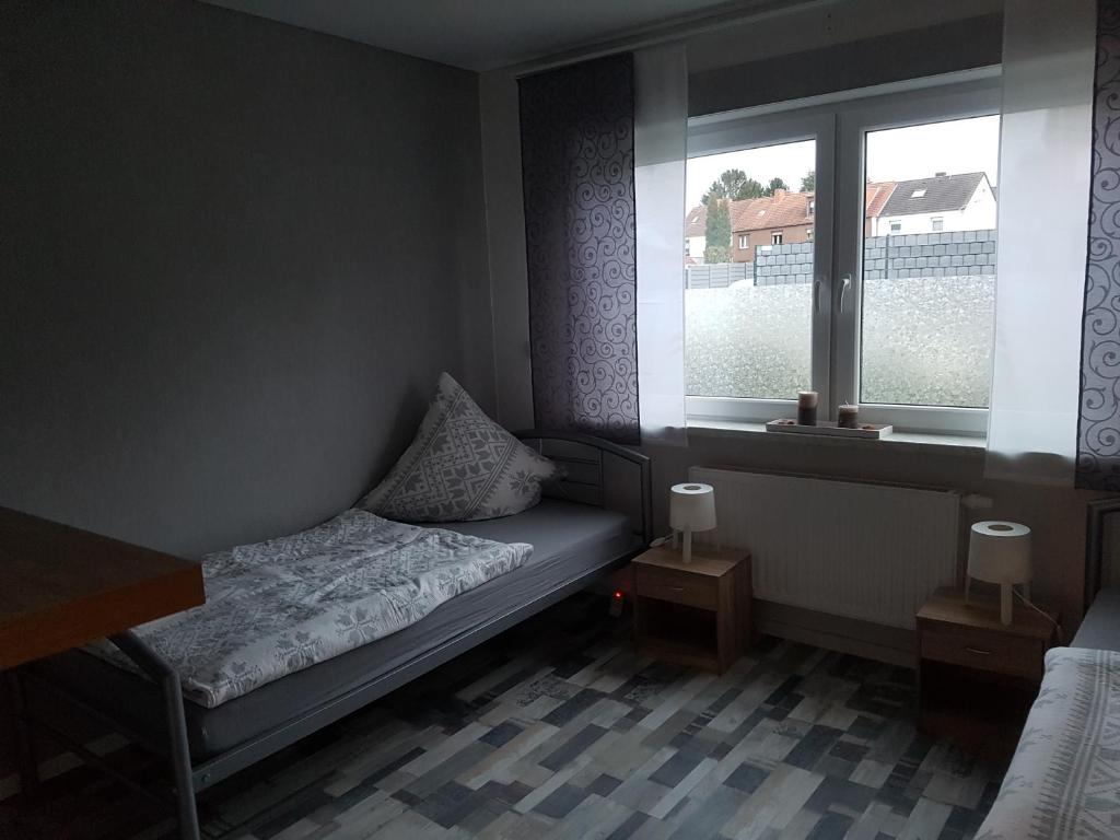 a small bedroom with a bed and a window at Ferienhaus Thalia 2 a in Übach-Palenberg