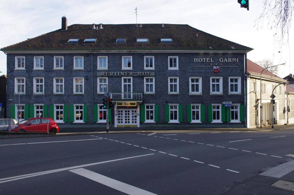 a large building on the corner of a street at Hotel Berliner Hof in Remscheid